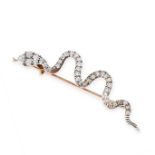 AN ANTIQUE DIAMOND AND RUBY SNAKE BROOCH in yellow gold and silver, in the form of a coiled snake,