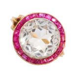 AN ART DECO WHITE SAPPHIRE AND RUBY TARGET RING in yellow gold, set with a central round cut white