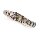 A DIAMOND AND RUBY OUROBOROS SNAKE RING in yellow gold and silver, designed as the body of a snake