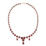 AN ANTIQUE GARNET AND PEARL NECKLACE in 15ct yellow gold, comprising a single row of graduated round