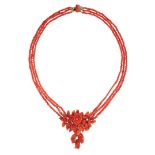 AN ANTIQUE CARVED CORAL NECKLACE, 19TH CENTURY comprising three rows of polished coral beads,
