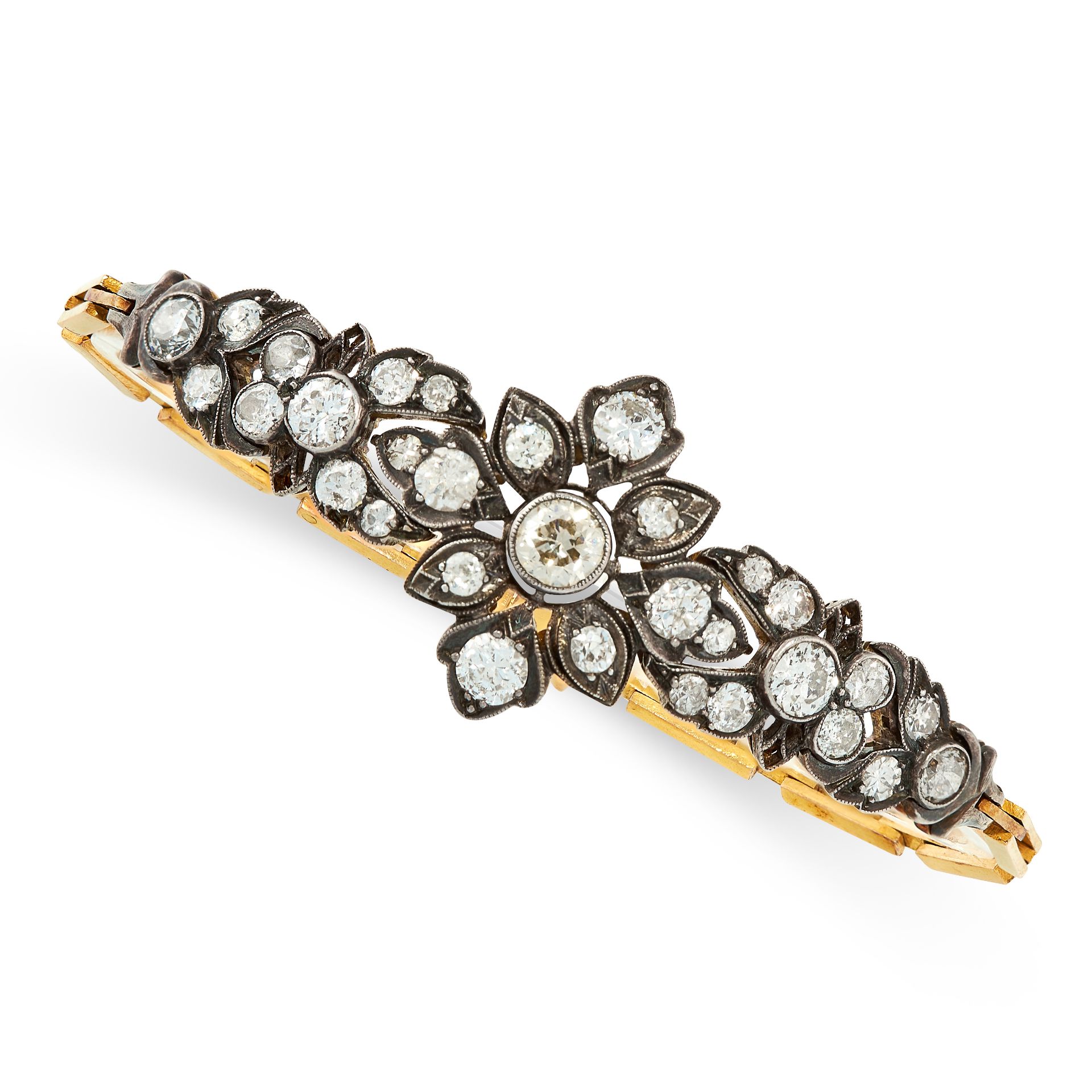 A DIAMOND BRACELET in yellow gold and silver, formed of a series of articulated foliate links, set