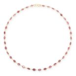 A GARNET CHAIN NECKLACE in yellow gold, comprising a single row of oval cut garnets, no assay marks,