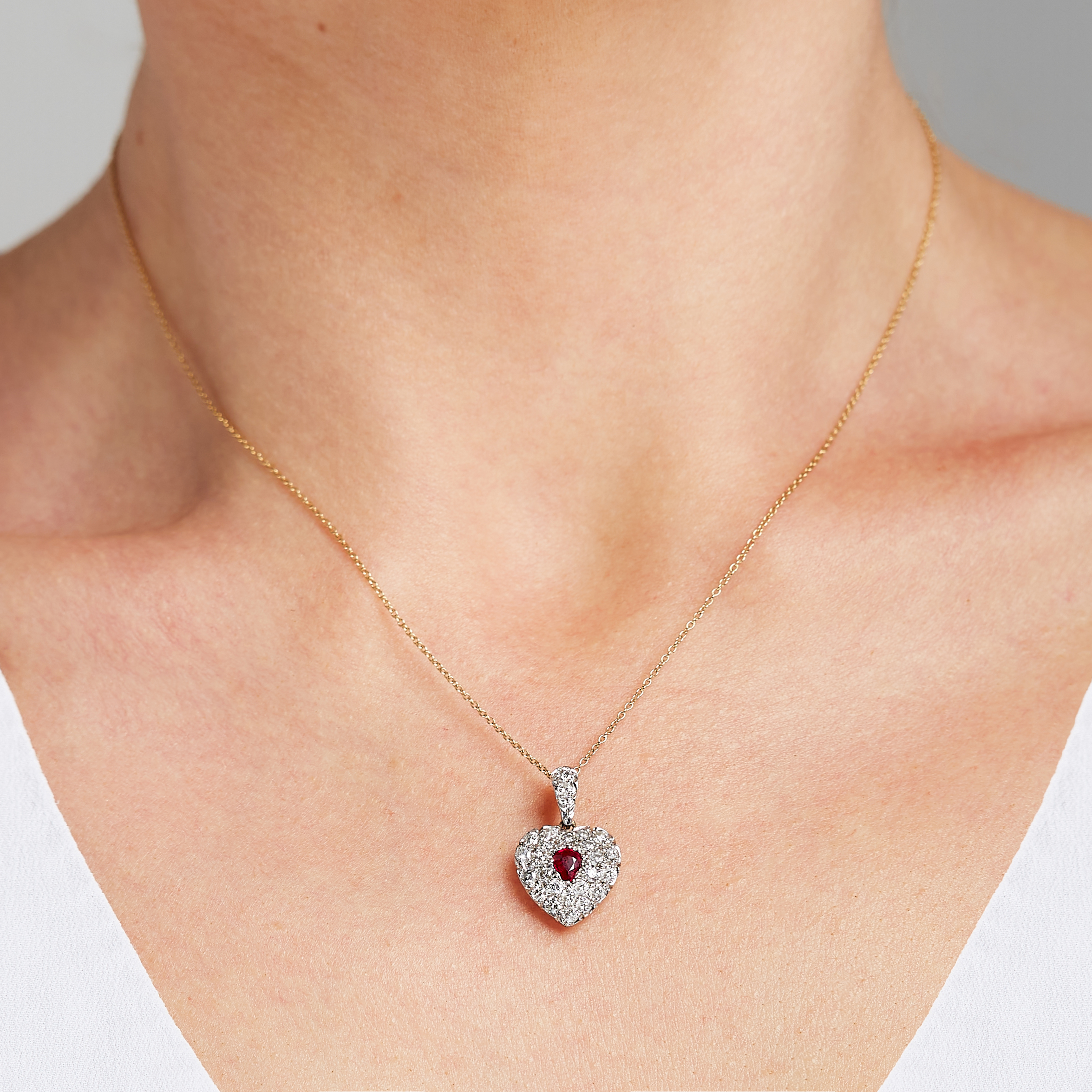 A RUBY AND DIAMOND HEART PENDANT in 15ct yellow gold, set with a pear cut ruby within a heart shaped - Image 2 of 2