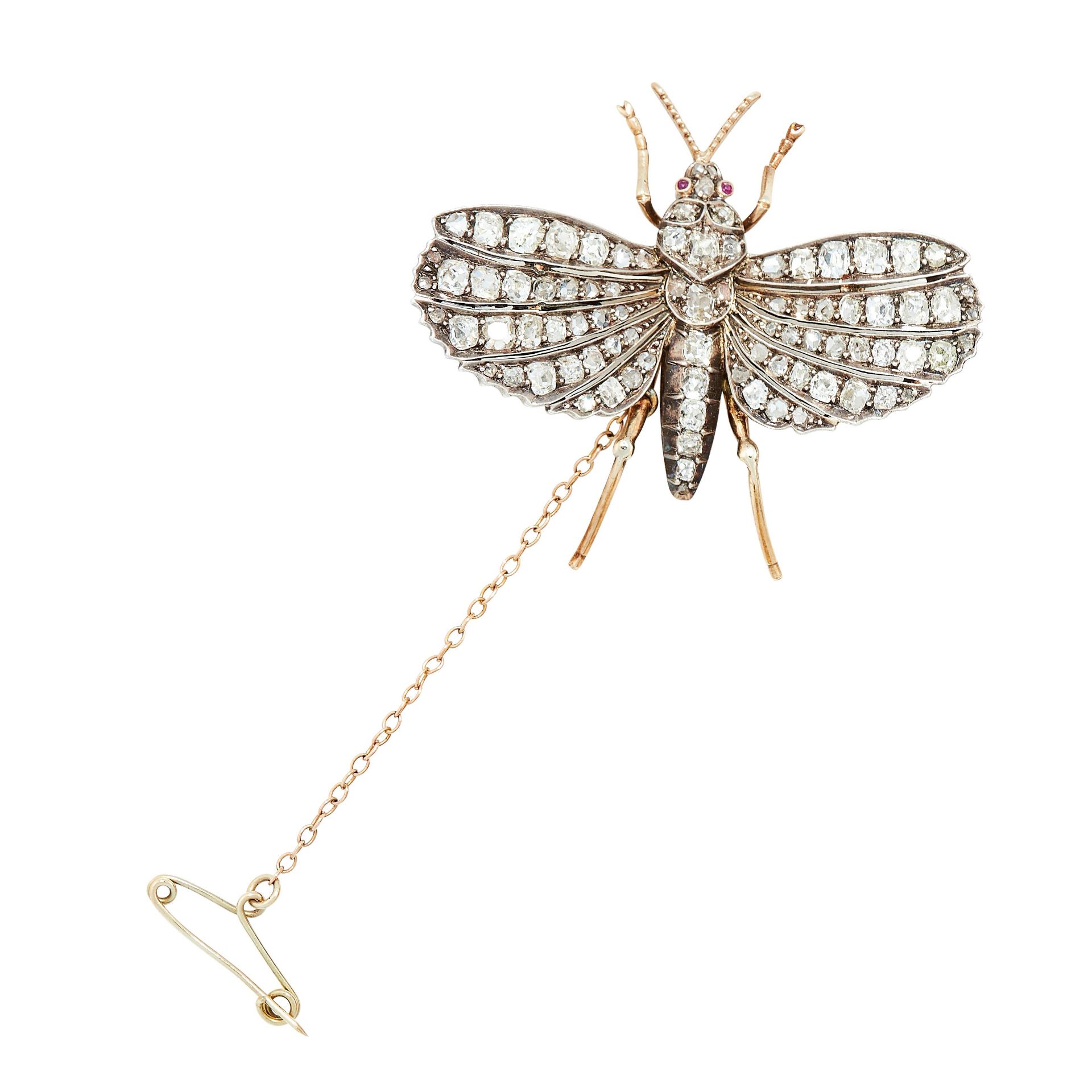 AN ANTIQUE DIAMOND AND RUBY MOTH BROOCH in yellow gold and silver, the body and wings jewelled