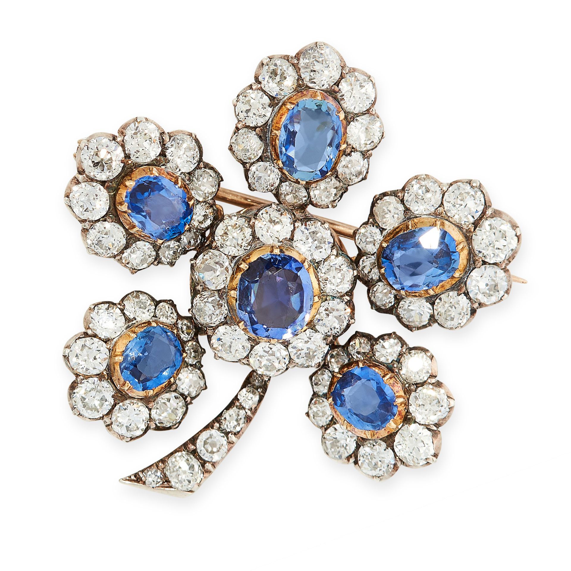 AN ANTIQUE SAPPHIRE AND DIAMOND FLOWER BROOCH in yellow gold and silver, set with six oval cut