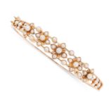 AN ANTIQUE PEARL BANGLE, LATE 19TH CENTURY in 15ct yellow gold, the openwork body applied with