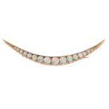 AN ANTIQUE OPAL AND DIAMOND CRESCENT MOON BROOCH in yellow gold, the tapering body set with a row of