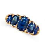 AN ANTIQUE SAPPHIRE RING in yellow gold, set with row of five graduated cushion cut sapphires, the