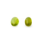 A PAIR OF UNMOUNTED PERIDOT cabochon cut, of 2.80 carats.