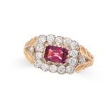 A RHODOLITE GARNET AND DIAMOND RING in yellow gold, set with an emerald cut rhodolite garnet in a