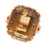 A CITRINE DRESS RING in yellow gold, set with an emerald cut citrine of 23.5 carats, within a