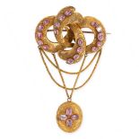 AN ANTIQUE PINK TOPAZ MOURNING LOCKET BROOCH, 19TH CENTURY in yellow gold, the scrolling body set