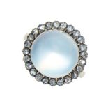 AN ANTIQUE MOONSTONE AND DIAMOND RING in yellow gold and silver, set with a central cabochon