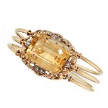 A VINTAGE CITRINE AND DIAMOND BANGLE in yellow gold, comprising of a central emerald cut citrine