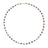 A GARNET CHAIN NECKLACE comprising a single row of graduated oval cut garnets, stamped 9K, 55.0cm,