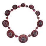 AN ANTIQUE GARNET NECKLACE, LATE 19TH CENTURY comprising of ten graduated clusters of oval