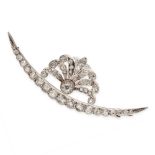 AN ANTIQUE DIAMOND CRESCENT MOON BROOCH in yellow gold and silver, the tapering body set with a