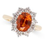 AN ORANGE SAPPHIRE AND DIAMOND RING in 18ct white and yellow gold, of cluster design, set with an