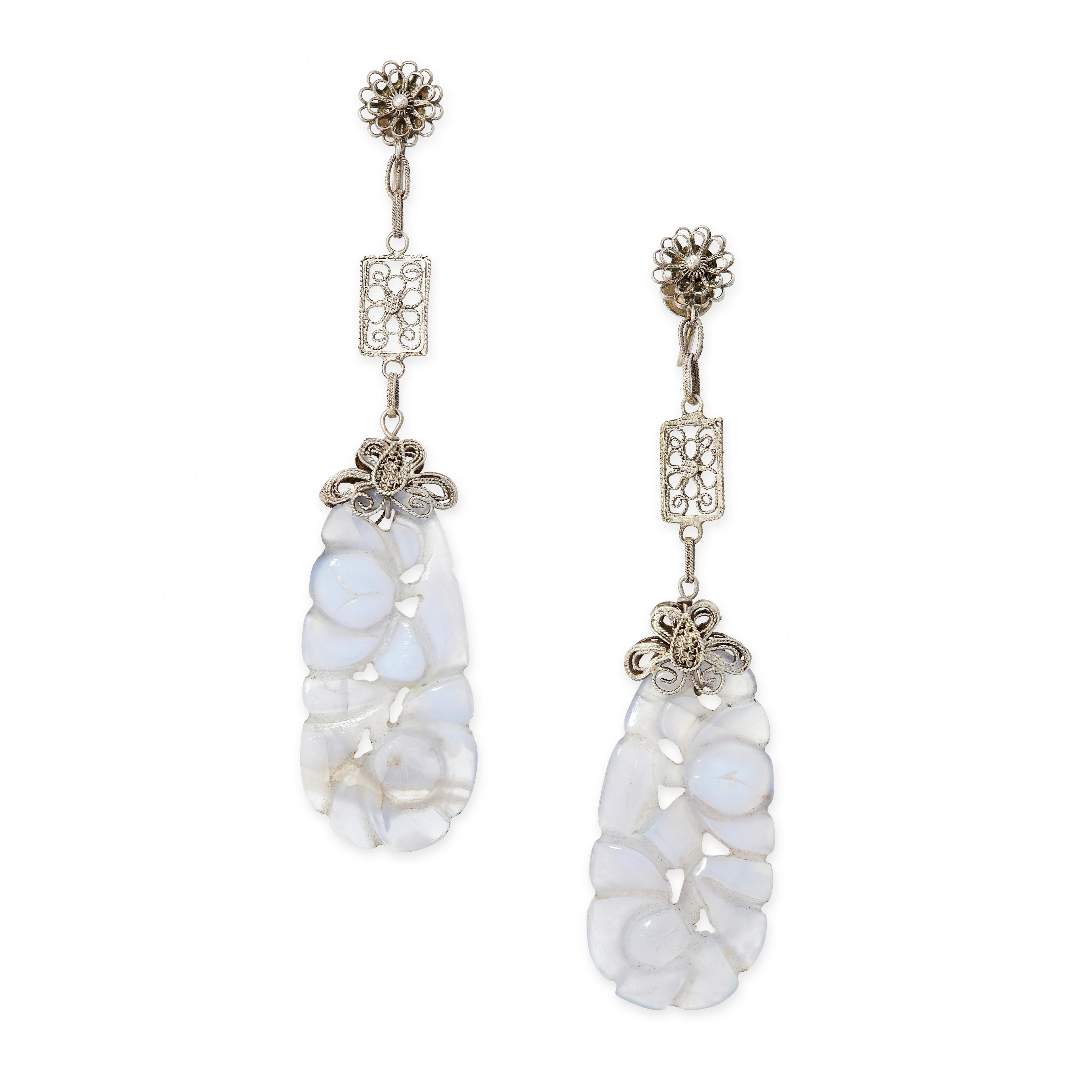 A PAIR OF ANTIQUE AGATE EARRINGS in silver, each formed of a carved and polished piece of pale