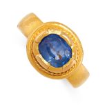 A SAPPHIRE DRESS RING in 22ct yellow gold, the band set to the front with a cushion cut blue