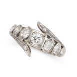 A DIAMOND DRESS RING set with a round cut diamond within a row of six old cut diamonds, between