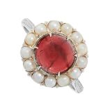 A GARNET AND PEARL RING in cluster design, set with a cabochon garnet of 2.98 carats in a border