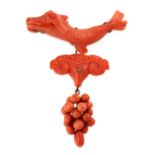 AN ANTIQUE CARVED CORAL BROOCH, 19TH CENTURY the articulated body set with carved pieces of coral