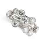 A DIAMOND DRESS RING in platinum, the open wirework band collet-set with round cut diamonds, the