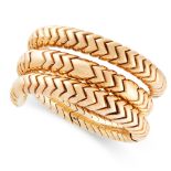 A SPIGA WRAP BRACELET / BANGLE, BULGARI in 18ct yellow gold, the coiled snake-like body formed of