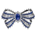 A BURMA NO HEAT SAPPHIRE AND DIAMOND BROOCH designed as a ribbon tied in a bow, set to the centre