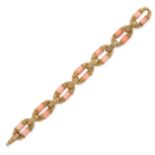 A VINTAGE CORAL FANCY LINK BRACELET in 18ct yellow gold, the seven principal textured links set with