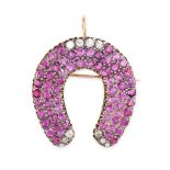 A BURMA NO HEAT PINK SAPPHIRE AND DIAMOND HORSESHOE BROOCH / PENDANT in yellow gold and silver,