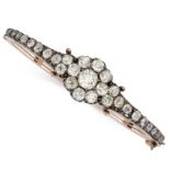 AN ANTIQUE DIAMOND BANGLE in yellow gold and silver, the tapering hinged body set to the front