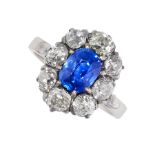 A KASHMIR SAPPHIRE AND DIAMOND RING in 18ct gold, set with a cushion cut blue sapphire of 1.76
