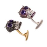 A PAIR OF AMETHYST AND SAPPHIRE SKULL CUFFLINKS in 18ct white and yellow gold, each designed as a