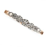 A DIAMOND BRACELET of woven design, set with old cut diamonds, within an oval link bracelet, no