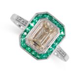 A DIAMOND AND EMERALD RING set with a step cut diamond weighing 1.54 carats, within a border of