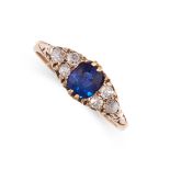 AN ANTIQUE SAPPHIRE AND DIAMOND RING set with a cushion cut blue sapphire between trios of old cut