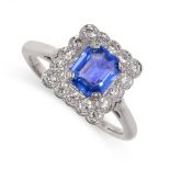 A SAPPHIRE AND DIAMOND DRESS RING set with a step cut blue sapphire weighing 1.16 carats, within a