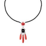 AN ONYX CORAL AND DIAMOND NECKLACE designed in the Art Deco style, the pendant set with polished