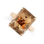 A SMOKY QUARTZ DRESS RING in yellow gold, claw set with a mixed octagonal cut smoky quartz