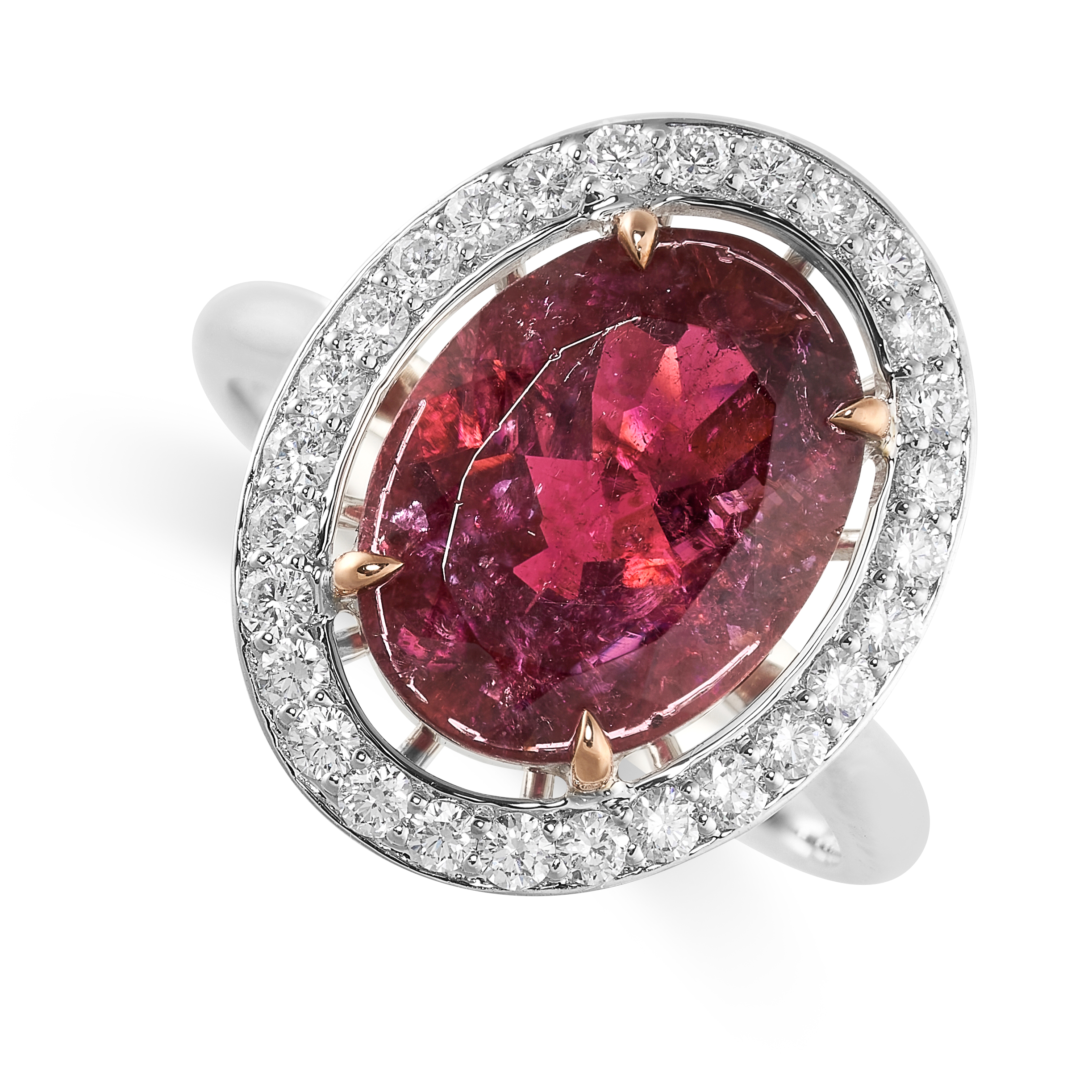 A PINK TOURMALINE AND DIAMOND RING set with an oval cut pink tourmaline weighing 3.93 carats