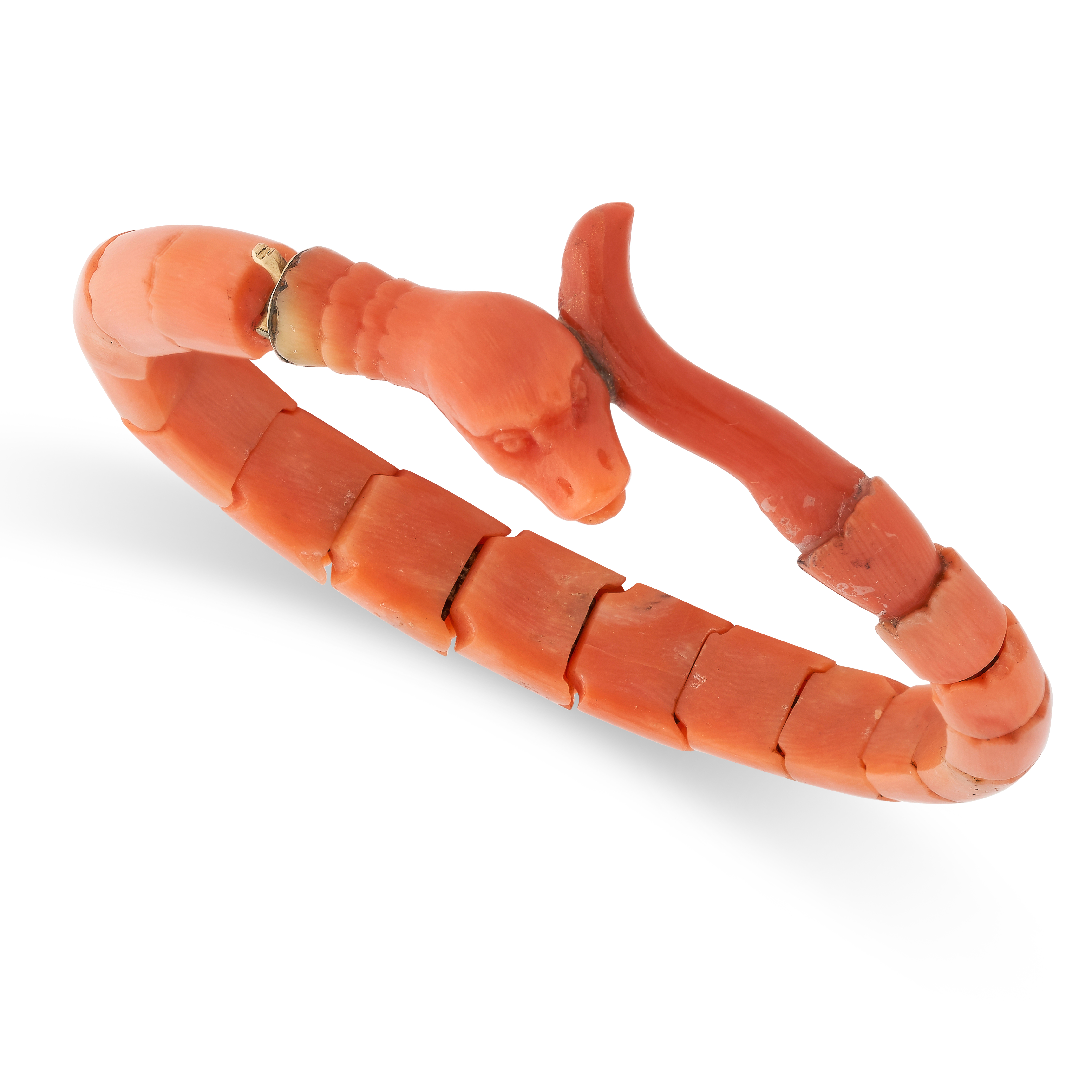 AN ANTIQUE CORAL SNAKE BANGLE / BRACELET, 19TH CENTURY designed to depict the body of a snake coiled