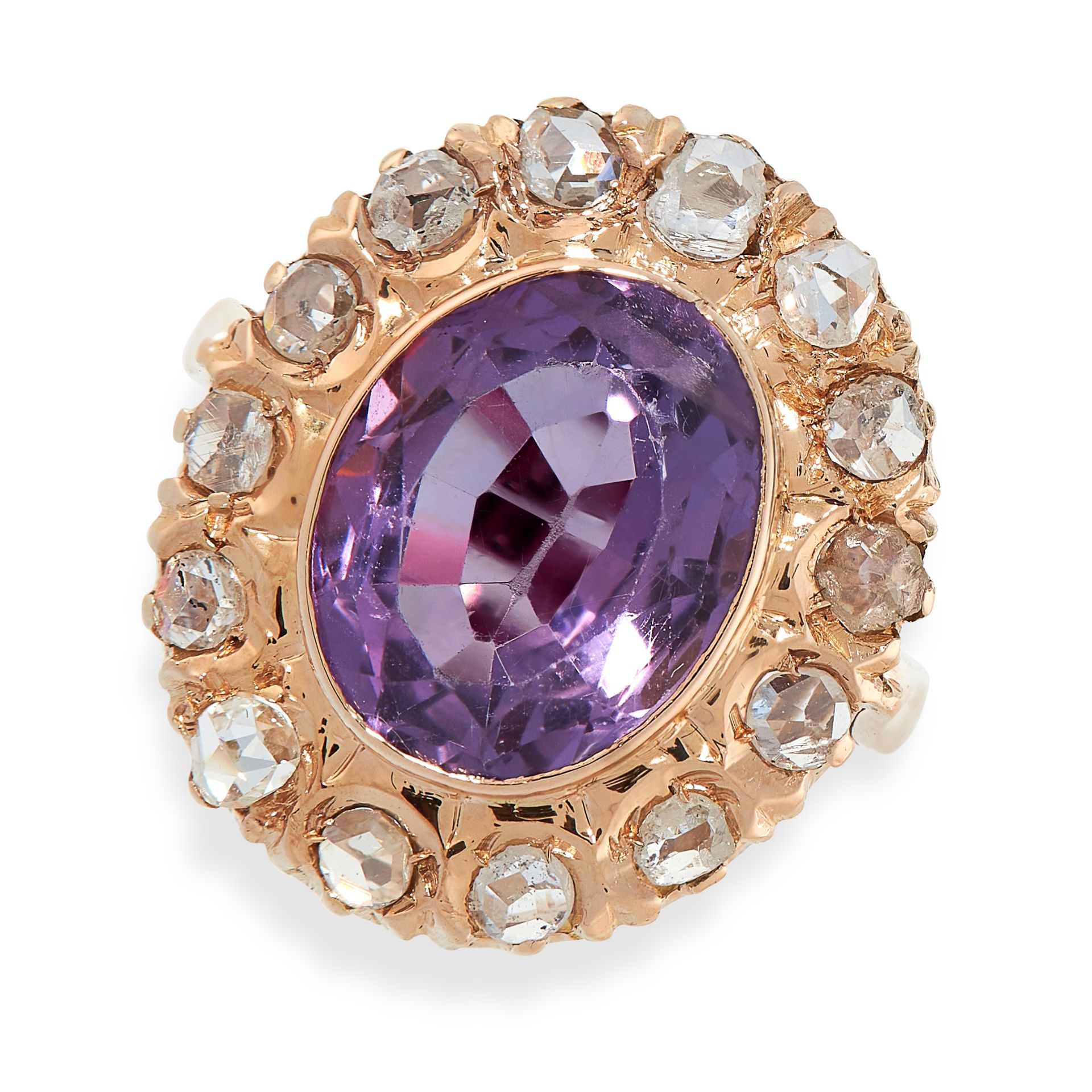 AN AMETHYST AND DIAMOND DRESS RING in yellow gold, set with an oval cut amethyst within a border