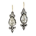 A PAIR OF ANTIQUE DIAMOND DROP EARRINGS in yellow gold and silver, each set with a pear shaped old