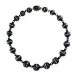 A BANDED ONYX, ONYX AND ROCK CRYSTAL NECKLACE  Polished banded agate, 125mm to 155m Banded onyx