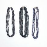 AN ASSORTED LOT OF PEARL NECKLACES comprising of a six row black pearl necklace, a four row black