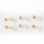 A MIXED LOT OF PEARL STUD EARRINGS comprising of three pairs, each set with a pearl, stamped 14K,