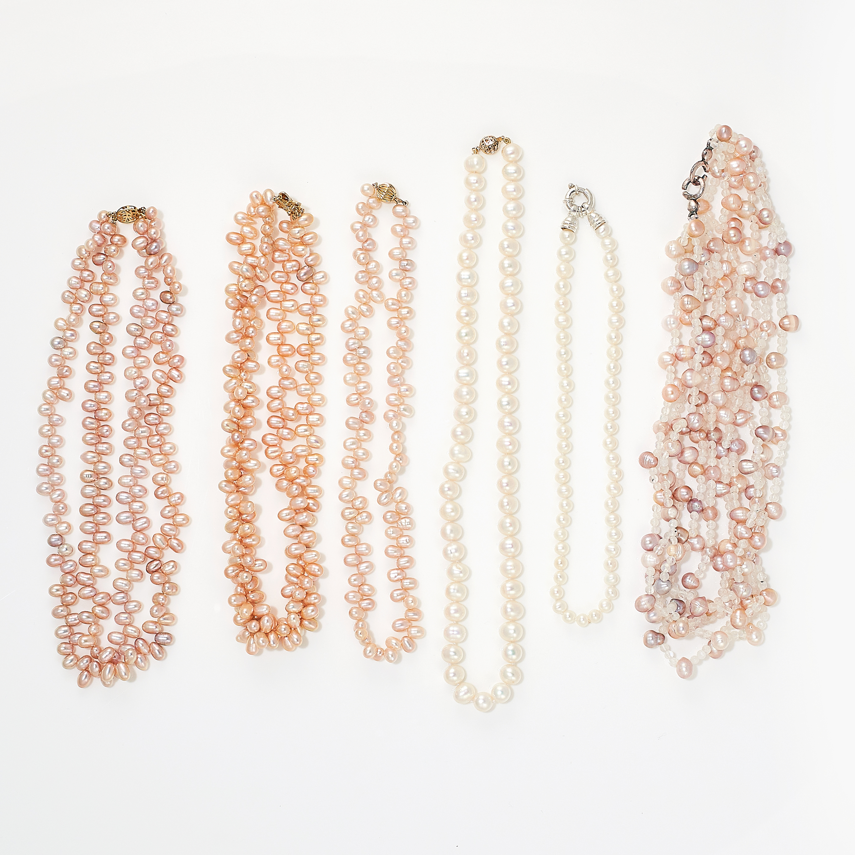 A MIXED LOT OF PEARL NECKLACES comprising of two single rows of white pearls, a five row pink